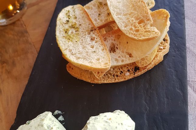 Aperitivo de hummus con un una crema de queso con pesto